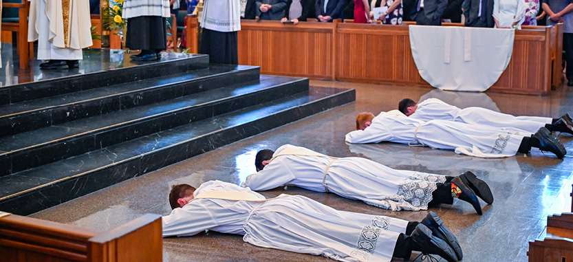 Four men taking priestly vows